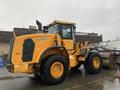 A yellow 2016 Hyundai HL940 wheel loader with large tires and a front loader attachment positioned in a parking lot