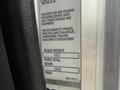 A metal truck specifications plate featuring details like scale weight and gross vehicle weight rating for a 2016 Peterbilt 348
