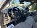 Interior view of a 2019 Ford F-150 highlighting the dashboard steering wheel and seats in gray upholstery
