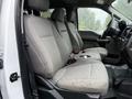 Interior view of a 2020 Ford F-550 showing the front seats with gray fabric upholstery and seat belts visible