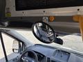 A 2018 Ford Transit-350 interior view showing the steering wheel dashboard and a round mirror mounted above