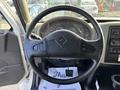 Steering wheel and dashboard of a 2012 International DuraStar 4300 with various gauges and controls visible