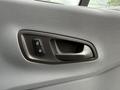 Close-up of a Ford Transit door handle featuring buttons for locking and unlocking the door
