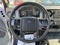 Steering wheel of a 2018 Ford F-750 with control buttons and dashboard displays in view