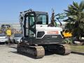 A 2010 Bobcat E80 excavator featuring a cab with controls and a track undercarriage designed for construction and excavation tasks