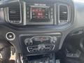 Interior dashboard of a 2017 Dodge Charger featuring a digital display screen with radio settings and climate control buttons