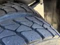 Close-up of the tire tread on a 2012 Autocar XPERT showcasing deep grooves and a rugged design for traction