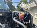 Close-up view of the engine compartment of a 2012 International 7300 Workstar showcasing the engine components hoses and fluid reservoir