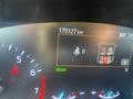 Dashboard display of a 2020 Ford Explorer showing odometer reading of 175127 km with a seatbelt warning icon and a notification for passenger seating status
