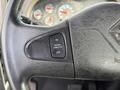 Close-up of a steering wheel with a cruise control switch labeled ON and OFF