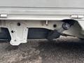 A 2008 Suzuki Carry showing the underside with the exhaust system and various mounting brackets visible