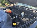 A 2015 RAM 1500 engine bay featuring a V8 engine with visible components including coolant reservoir brake fluid reservoir and various hoses and connectors
