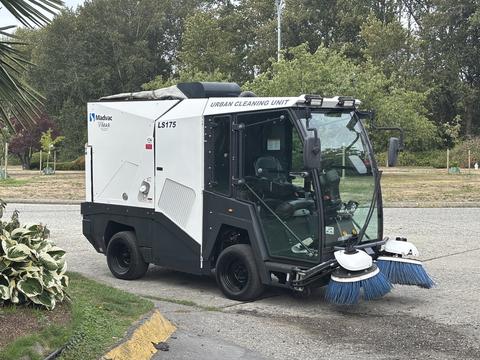 A 2019 Madvac LS175 urban cleaning unit with a compact design featuring dual front brushes and a large windshield for visibility and operation