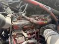 Close-up of a 2016 Freightliner 108SD engine showing various pipes wires and components in a mechanical layout