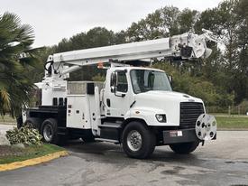A white 2013 Freightliner 114SD bucket truck with a lift arm and equipment storage compartments on the side