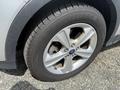 A close-up of a silver 2015 Ford Escape wheel showing the alloy rim and tire tread without any visible damage