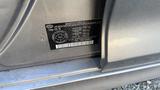 A 2018 Hyundai Sonata with a vehicle identification number sticker on its side panel