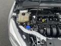 Close-up of the engine bay of a 2018 Ford Focus showing the coolant reservoir cap a dipstick and various engine components