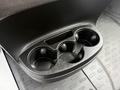 A black cup holder with four circular sections designed for holding beverages in a 2020 RAM Promaster