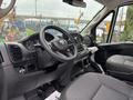 Interior of a 2023 RAM Promaster 3500 featuring a steering wheel dashboard and driver seat with a modern design and control panel