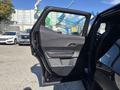 The image features the open door of a 2023 Fisker Ocean showcasing its interior design and controls