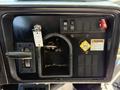 Dashboard of a 2013 International CE300 showing various buttons switches and warning labels