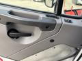 Close-up of a 2013 Freightliner 114SD truck door handle and control panel featuring a black handle and several ergonomic buttons and switches
