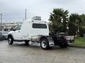 A 2024 RAM 5500 with a white body and refrigeration unit on the back featuring large wheels and a distinctive rear design