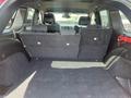 Interior view of the back of a 2015 Jeep Grand Cherokee with folded rear seats and a spacious cargo area