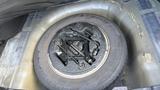 A 2018 Hyundai Sonata's trunk showing a spare tire with a jack and tools placed on top of it