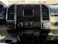 The dashboard of a 2019 Ford F-550 featuring a central control panel with audio and climate controls as well as a display screen