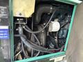 The image shows the engine compartment of a 2011 Ford F-650 with various components including pipes electrical connections and a metal casing