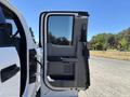 A 2020 Ford F-350 SD with the passenger door open revealing the interior features including seats and storage compartments