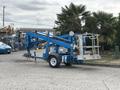 A blue 2016 Genie TZ-34/20 aerial lift with outriggers and a platform for reaching high elevations