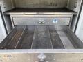Close-up of a metal drawer system with multiple compartments and a large pull handle designed for storage in a vehicle or utility space