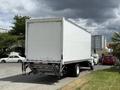 A 2022 International MV607 box truck with a white cargo area visible from the rear