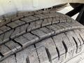 A close-up of the tire of a 2022 Mercedes-Benz Sprinter showing tread patterns and some dirt on the surface