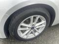 Close-up of a silver 2018 Ford Focus wheel with alloy rims and a black tire showcasing the tread pattern