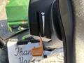 A close-up view of the control dial on a 2021 John Deere 1575 with an orange lever positioned within the marked slot indicating functionality