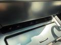 Close-up of the control panel in a 2004 BMW 6-Series featuring buttons for heated seats and dynamic stability control
