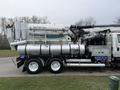 A 2013 International Workstar 7500 truck with a large tank and various plumbing equipment attached to the side