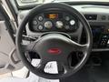 Steering wheel of a 2016 Peterbilt 348 with gauges and controls visible on the dashboard