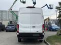 A white 2020 Ford Transit 250 van is parked, showing its rear view with a clean design and the logo visible on the back door
