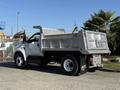A 2017 Ford F-650 Super Duty dump truck with a metal bed and black branding on the rear wheel well