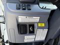 A control panel featuring switches and warning labels for a 2015 Mitsubishi Fuso FE