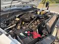 A 2009 Ford F-550 engine bay showing various components including the battery hoses and engine parts