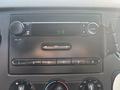 The dashboard of a 2009 Ford F-550 showing the radio controls and a digital clock displaying 9:18