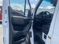 Interior view of a 2025 Mercedes-Benz Sprinter with the driver's side door open showcasing the dashboard and steering wheel