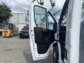 A 2023 RAM Promaster 3500 van with the driver's side door open showcasing its interior features and seating area