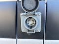 Close-up of a power connection port on a 2021 Mercedes-Benz Sprinter 2500 with a protective cap removed